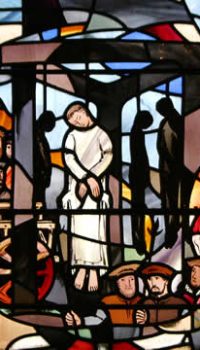 Photograph by Tommy Heyne. This window shows Houghton, prior of a Carthusian house, and three fellow Carthusians, who were hung, drawn, and quartered at Tyburn after refusing to take the oath that recognized Henry VIII as head of the Church. Thomas More, watching them go to their deaths from his cell window in the Tower, said to his daughter Margaret, "Look, Meg, these blessed Fathers be now as cheerfully going to their deaths as bridegrooms to their marriage!" The figure on horseback on the right panel of the window is Henry VIII. John Houghton and the Carthusians at Tyburn